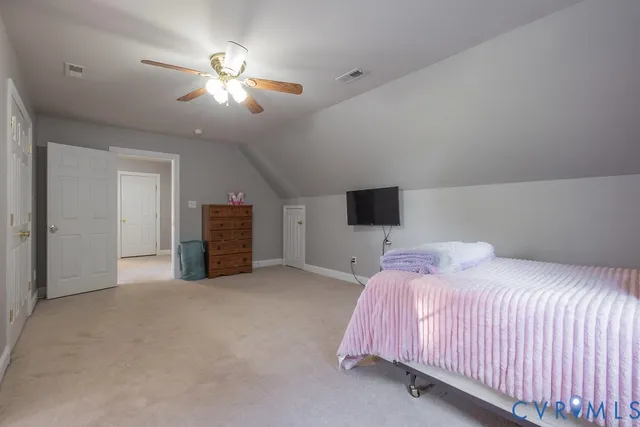 a bedroom with a bed and a ceiling fan