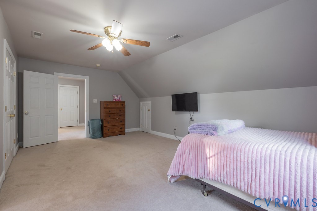 15438 West Patrick Henry Road Montpelier, VA 23192 - Photo 30 of 45 a bedroom with a bed and a ceiling fan