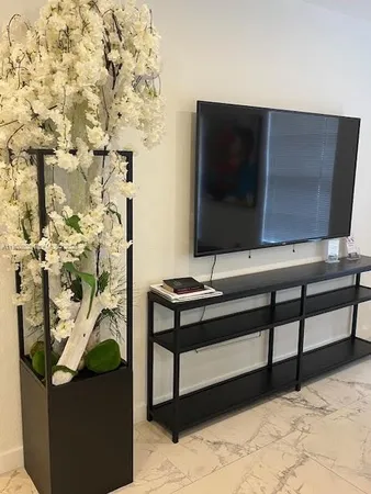 a living room with a wooden floor and a flat screen tv