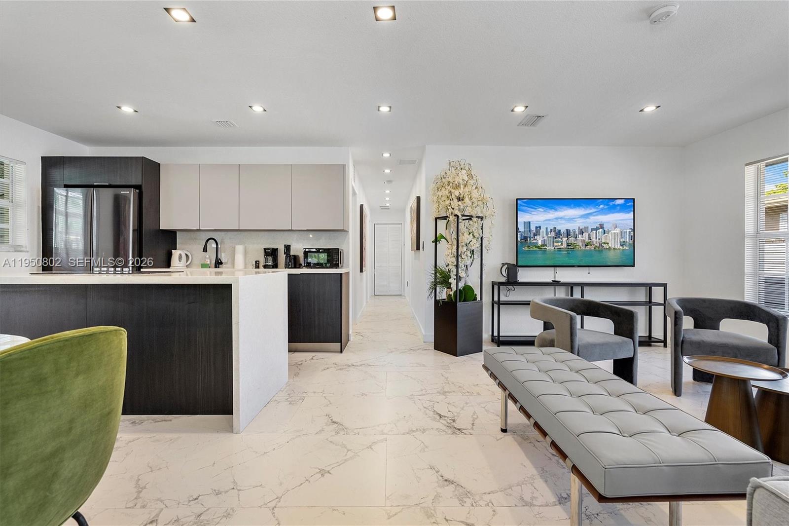 270 Northwest 41st Street Miami, FL 33127 - Photo 15 of 30 a living room with stainless steel appliances furniture a rug and a kitchen view