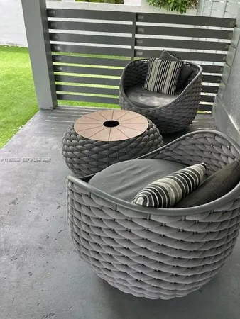 a view of a wooden table and chairs in the patio