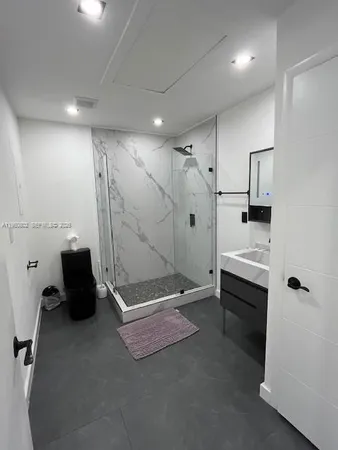a bathroom with a sink toilet and mirror
