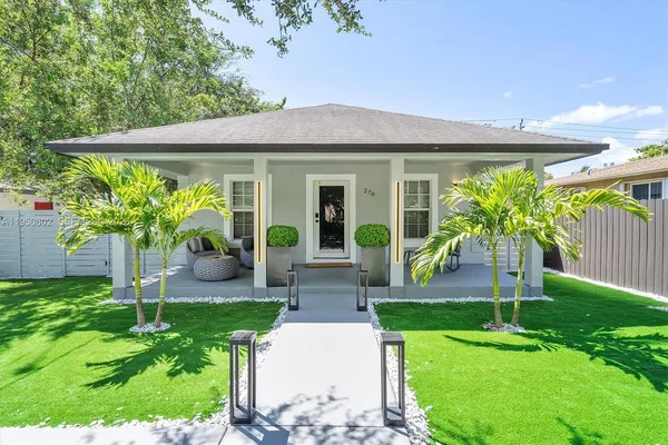 a view of a house with backyard and a garden