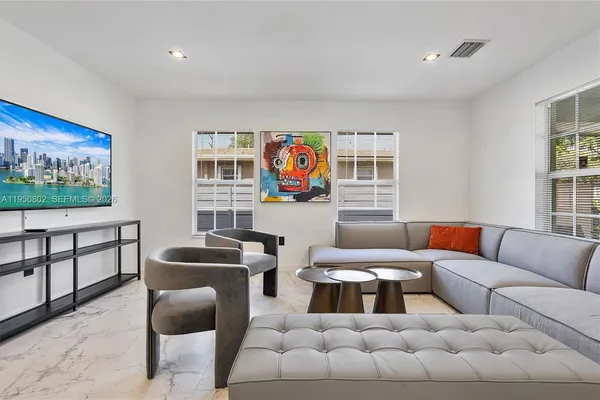 a kitchen with stainless steel appliances granite countertop a table and chairs