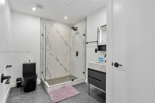 a kitchen with stainless steel appliances granite countertop a sink a stove and a refrigerator