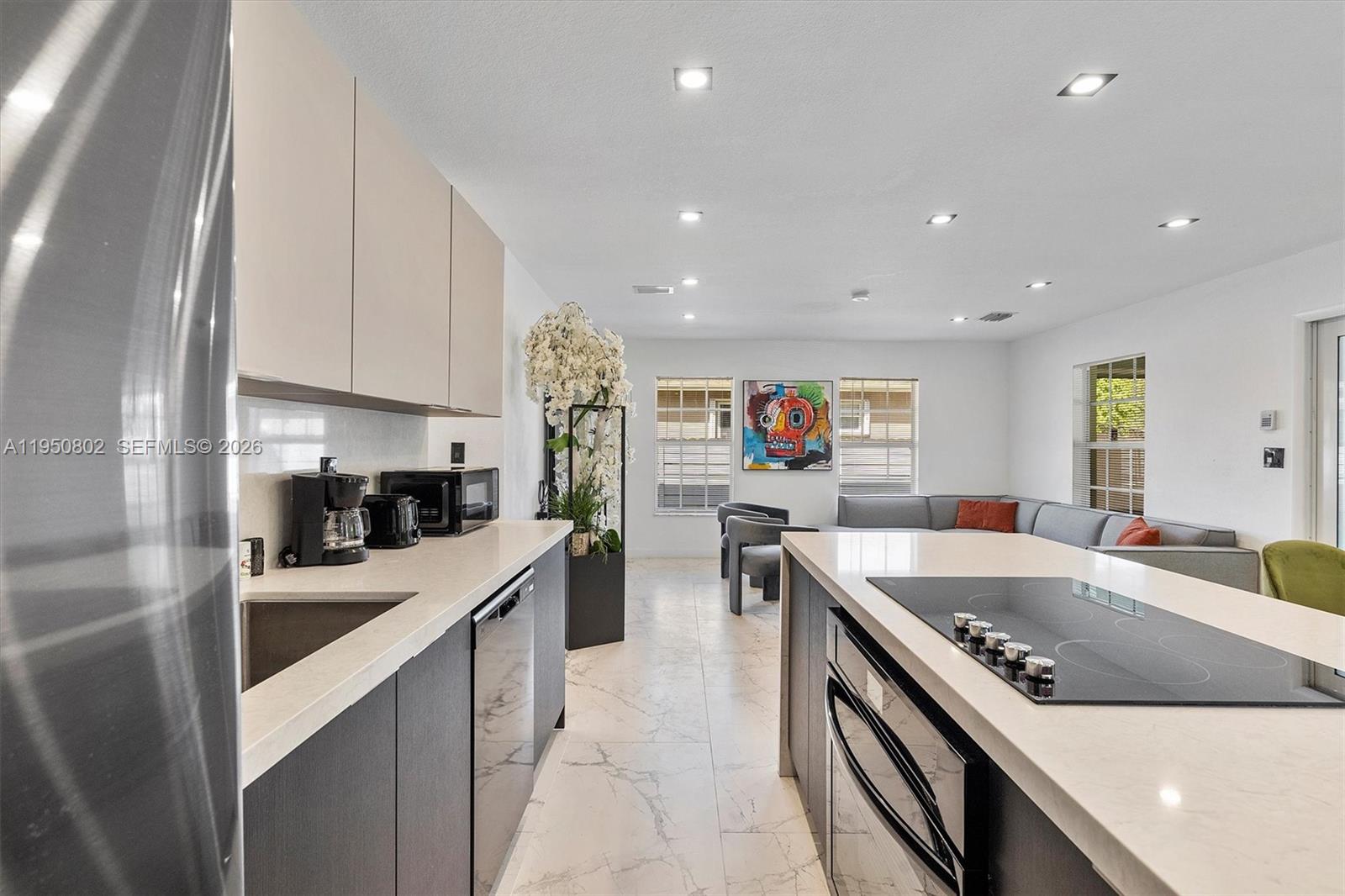 270 Northwest 41st Street Miami, FL 33127 - Photo 27 of 30 a kitchen with stainless steel appliances granite countertop a sink a stove and a refrigerator