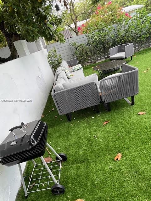 270 Northwest 41st Street Miami, FL 33127 - Photo 30 of 30 a backyard of a house with table and chairs