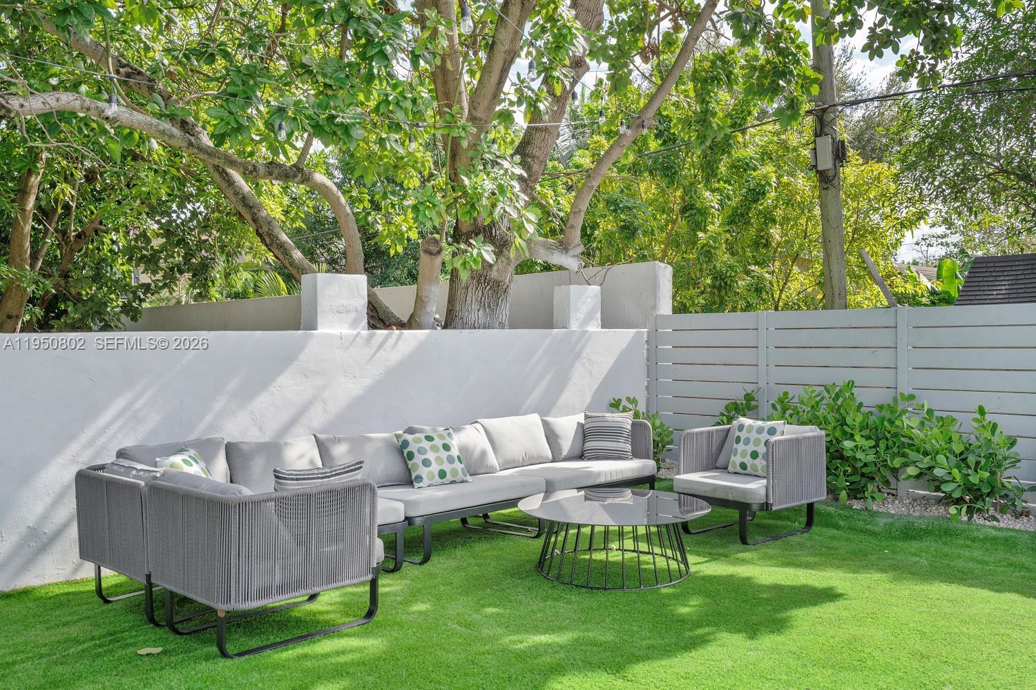 270 Northwest 41st Street Miami, FL 33127 - Photo 3 of 30 a view of a couches in a patio with a yard