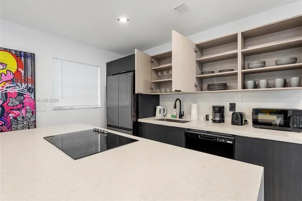 a kitchen with stainless steel appliances a sink a stove and a refrigerator