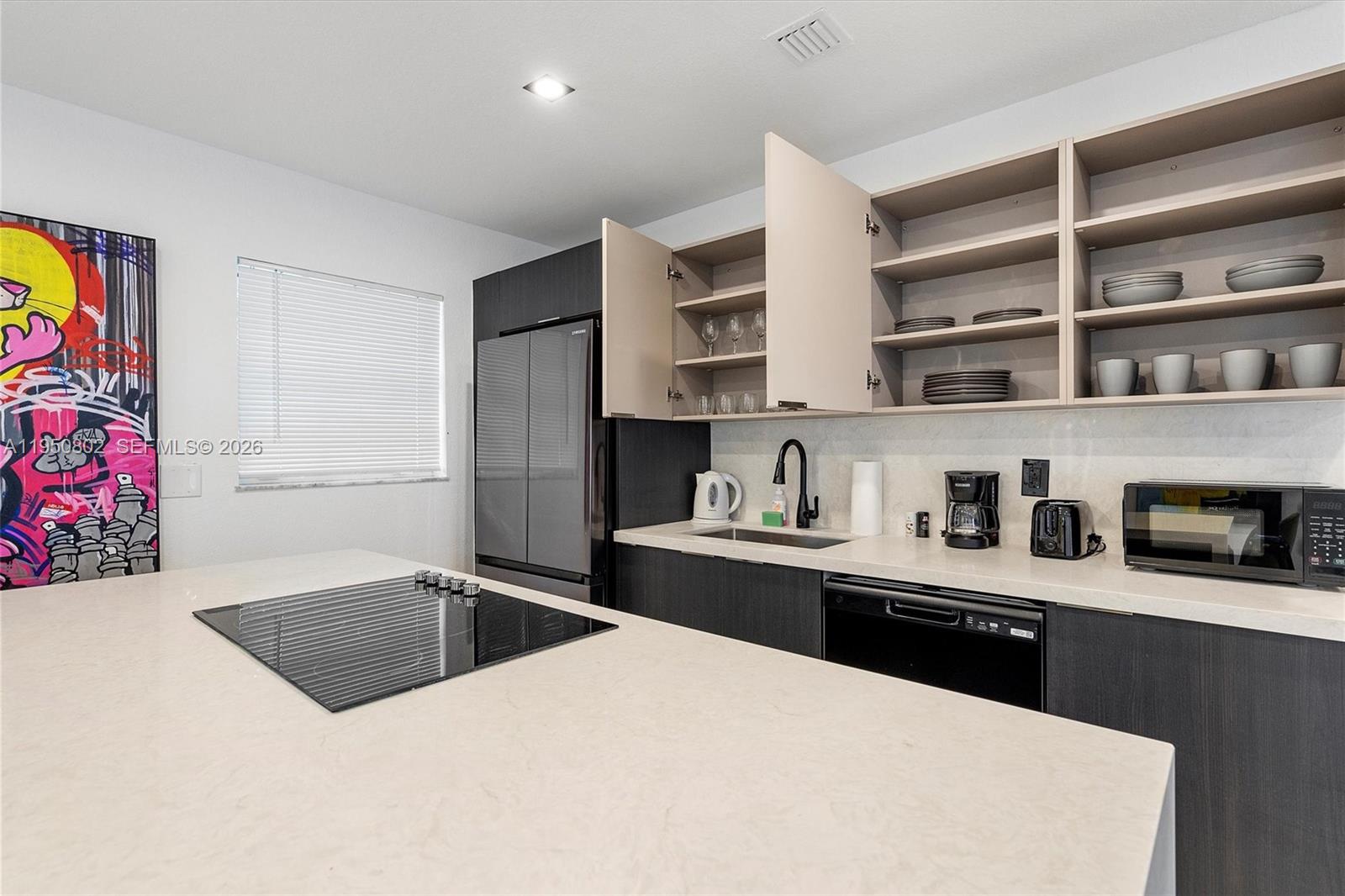 270 Northwest 41st Street Miami, FL 33127 - Photo 4 of 30 a kitchen with stainless steel appliances a sink a stove and a refrigerator