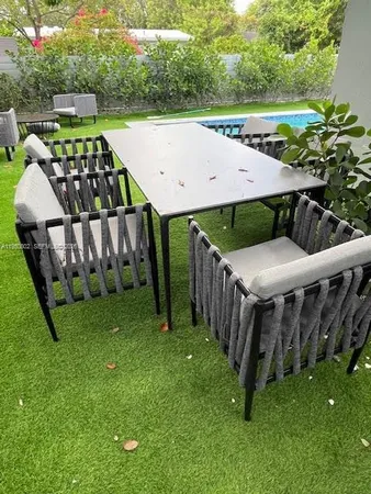 a view of a backyard with sitting area and furniture