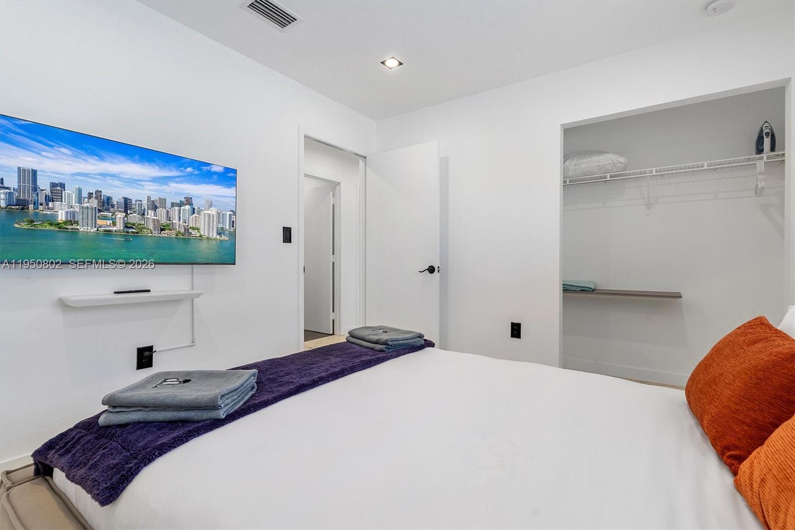 270 Northwest 41st Street Miami, FL 33127 - Photo 8 of 30 a bedroom with a large bed and a flat screen tv