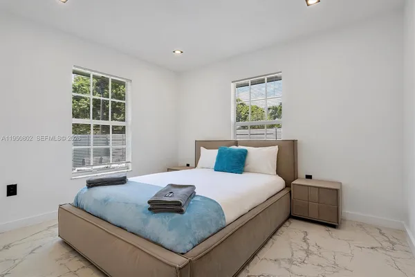 a bedroom with a bed and a window
