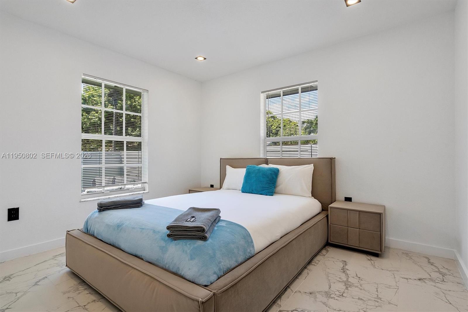 270 Northwest 41st Street Miami, FL 33127 - Photo 10 of 30 a bedroom with a bed and a window