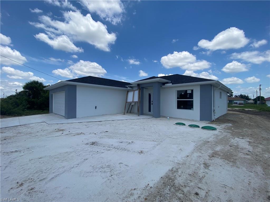 2812 15th Street Southwest Lehigh Acres, FL 33976 - Photo 12 of 13 a view of a house with a backyard space and a yard