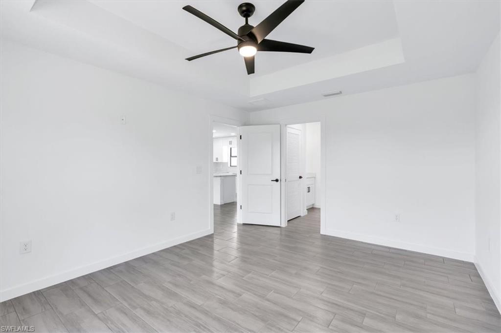 2812 15th Street Southwest Lehigh Acres, FL 33976 - Photo 5 of 13 a view of an empty room with window and wooden floor