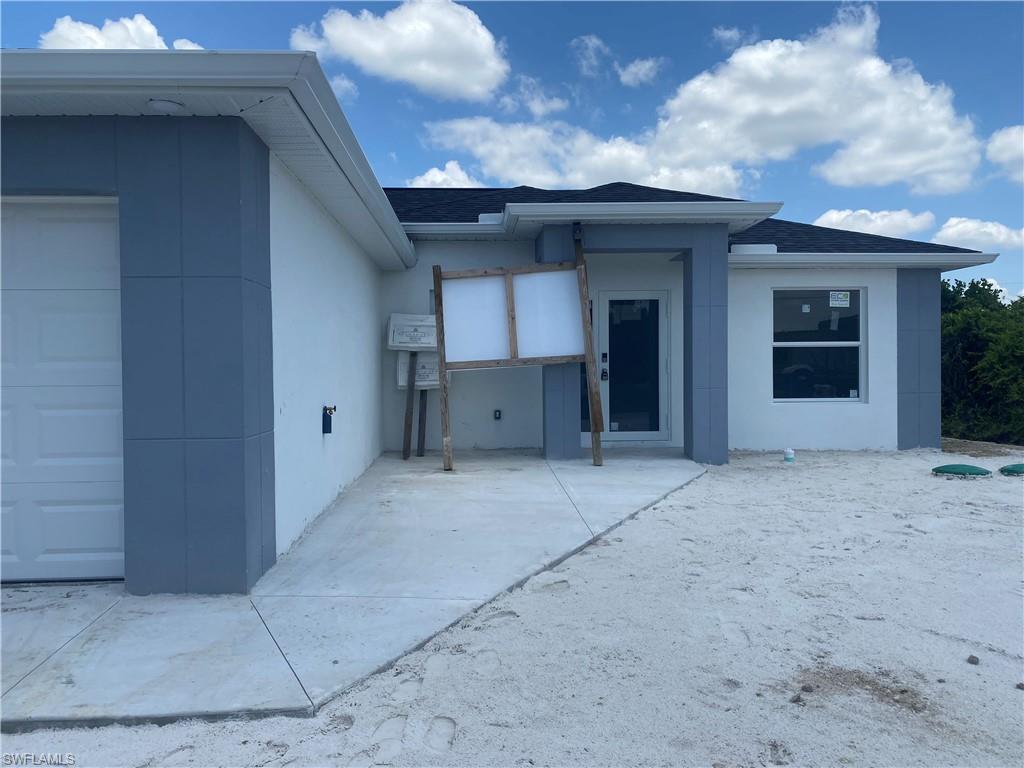 2812 15th Street Southwest Lehigh Acres, FL 33976 - Photo 10 of 13 a view of a house with entryway and a street