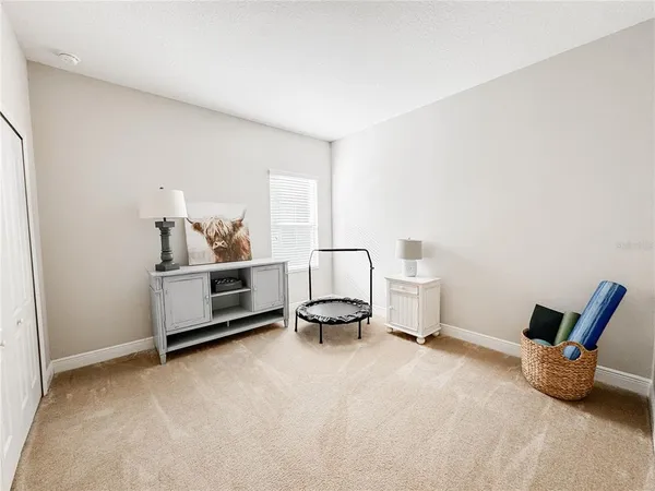 a bedroom with a bed and a chair