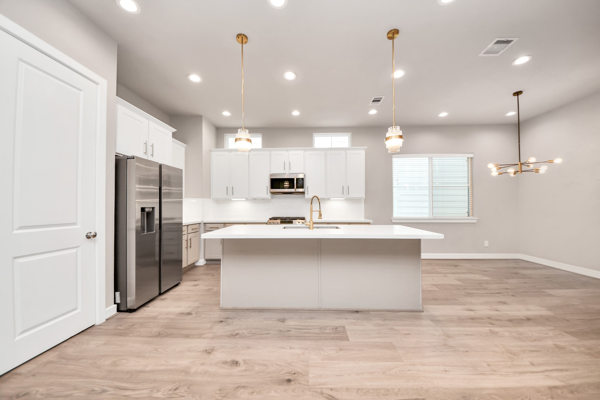 2114 Stuart Street Houston, TX 77004 - Photo 4 of 39 a large kitchen with kitchen island a sink stainless steel appliances and a counter top