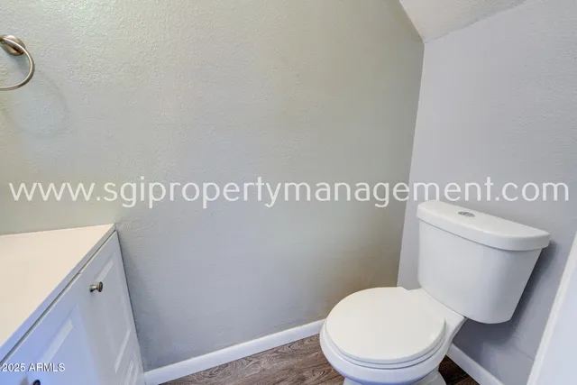 a white toilet sitting next to a bathroom sink