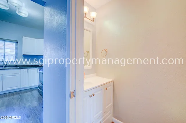 a kitchen with a sink a refrigerator and cabinets