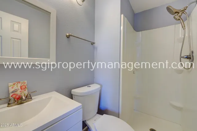 a white toilet sitting next to a bathroom sink