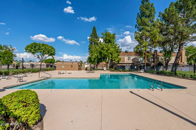 a view of a swimming pool and a yard