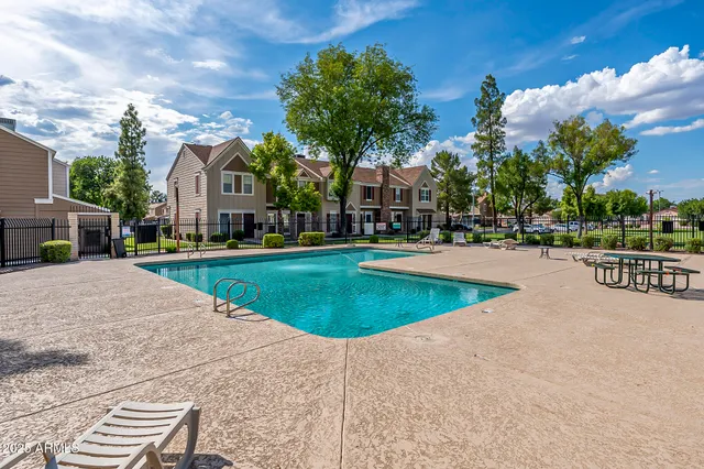 a view of a garden with lawn chairs and a big yard