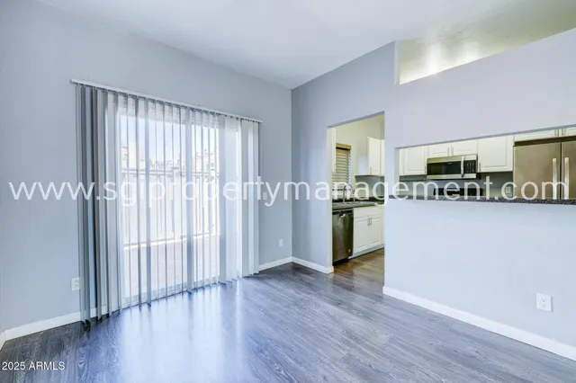 a kitchen with stainless steel appliances granite countertop a refrigerator sink and microwave