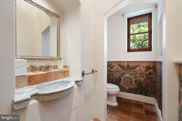 a spacious bathroom with a double vanity sink a mirror and a bathtub