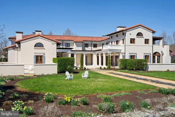 a backyard of a house with lots of green space and fountain