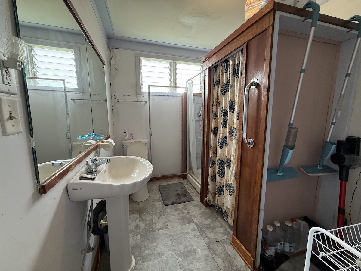 37 Mehau Lane Hilo, HI 96720 - Photo 18 of 24 a bathroom with a sink a toilet and shower