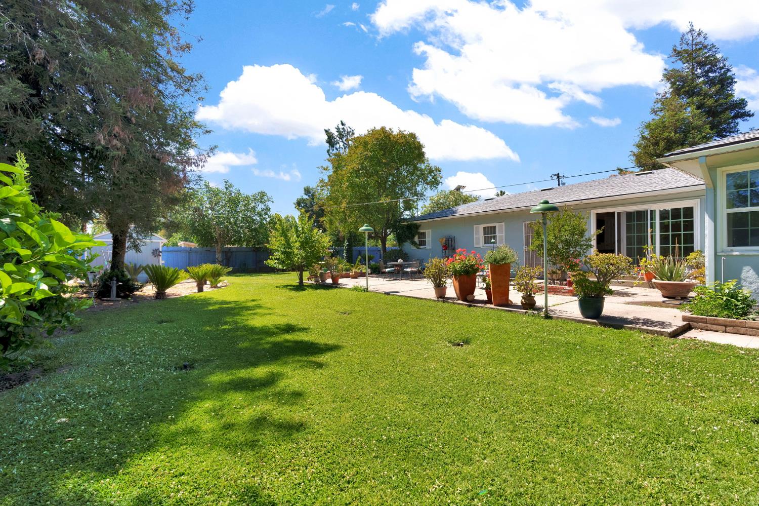 200 Lyons Street Madera, CA 93638 - Photo 28 of 32 a view of a patio with couches chairs and a big yard