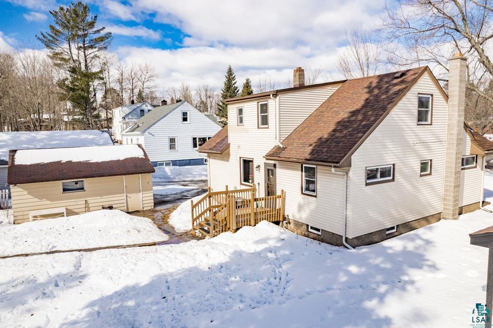 2615 Springvale Road Duluth, MN 55811 - Photo 33 of 46 Snow covered back of property with a shingled roof and a chimney