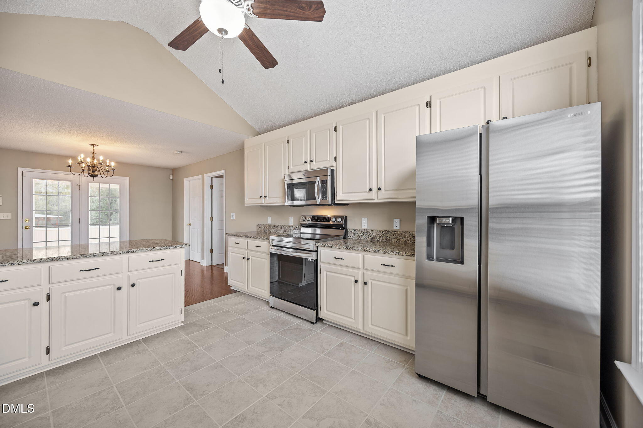 115 Edmondson Drive Willow Spring, NC 27592 - Photo 11 of 39 a large kitchen with cabinets stainless steel appliances and a window