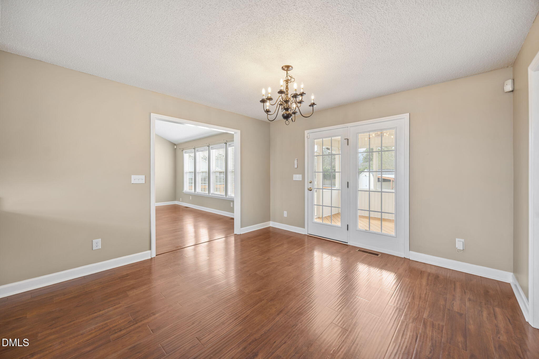 115 Edmondson Drive Willow Spring, NC 27592 - Photo 13 of 39 a view of an empty room with wooden floor and a window