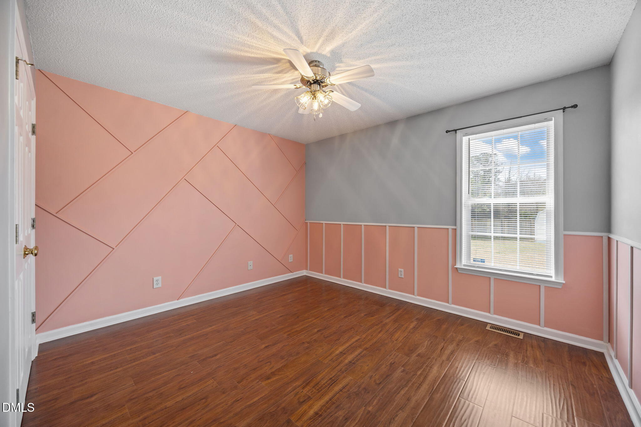 115 Edmondson Drive Willow Spring, NC 27592 - Photo 22 of 39 an empty room with wooden floor fan and windows