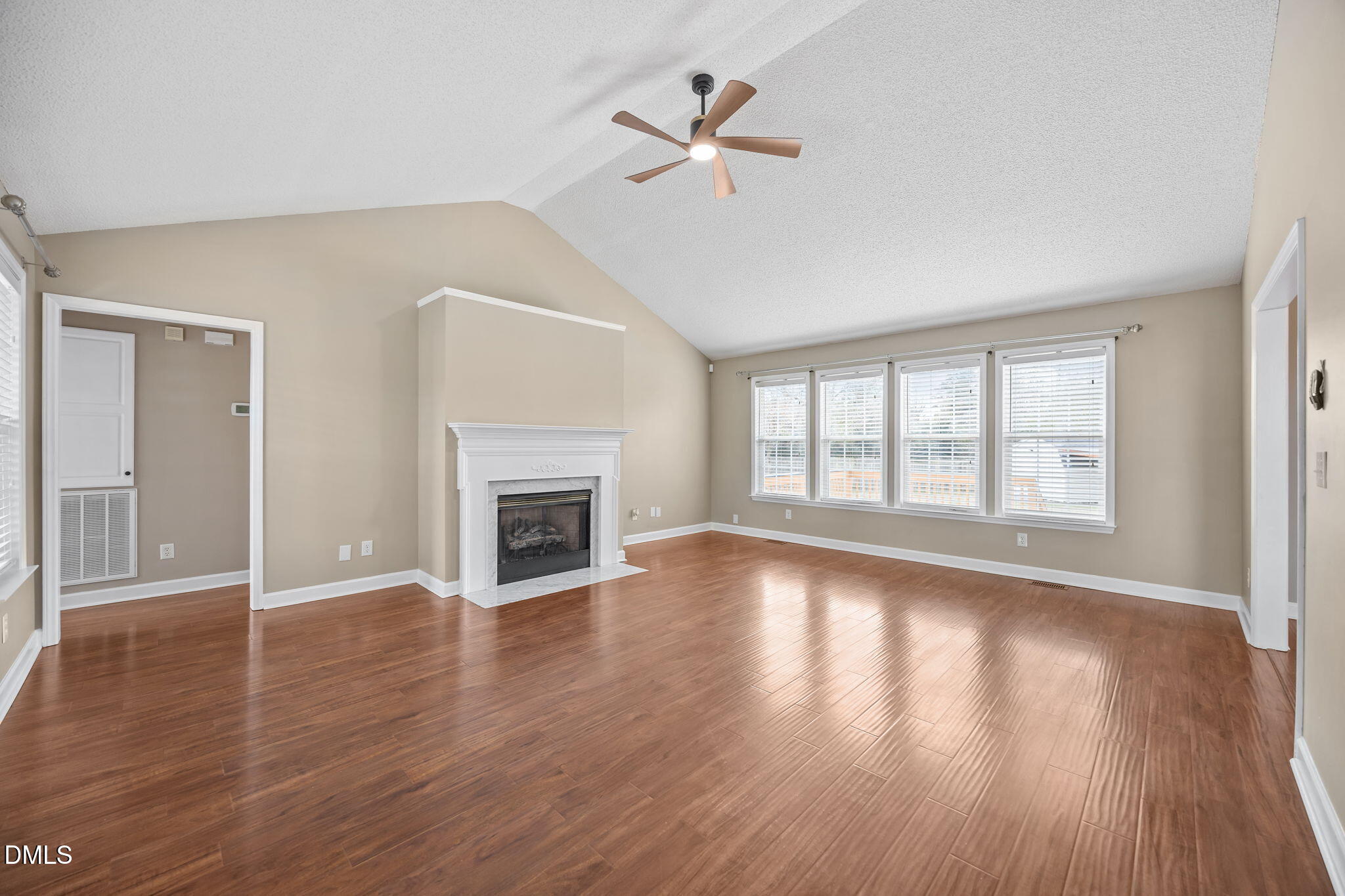 115 Edmondson Drive Willow Spring, NC 27592 - Photo 4 of 39 a view of an empty room with wooden floor and a window