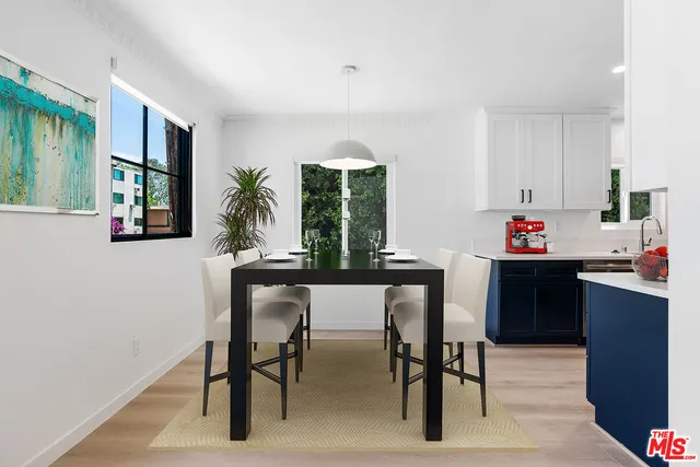 a kitchen with a table and chairs in it