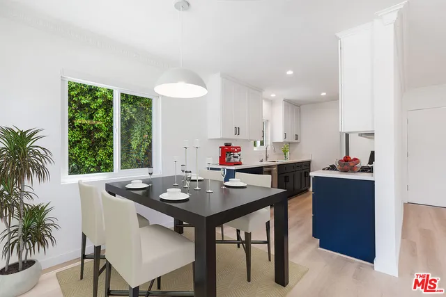 a kitchen with a table and chairs in it