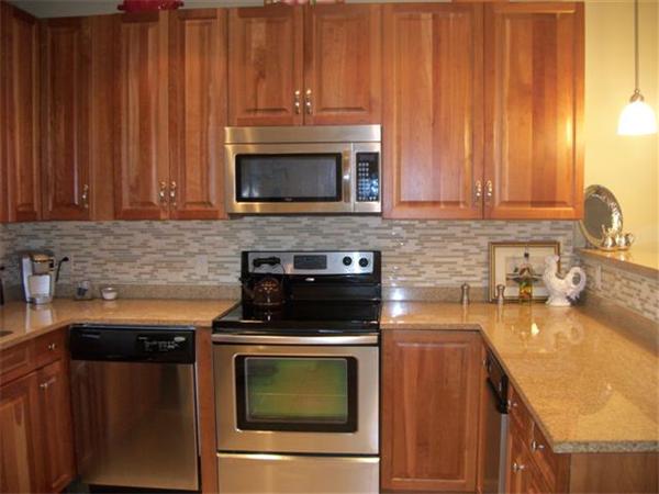 906 Alder Way, Unit 906 North Andover, MA 01845 - Photo 4 of 17 a kitchen with a stove microwave and sink