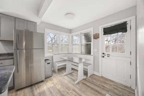 a living room with fireplace furniture and a large window