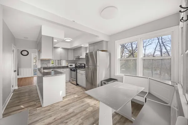 a kitchen with a refrigerator a sink and cabinets