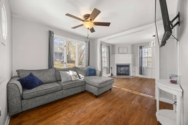 a view of empty room with wooden floor and fireplace