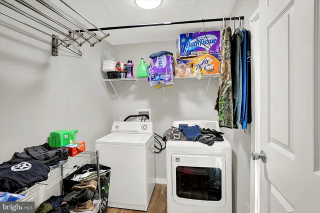 a utility room with fridge dryer and washer
