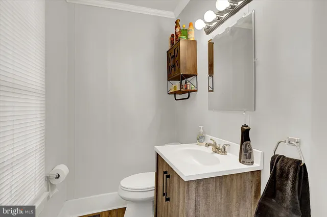 a bathroom with a sink toilet and mirror