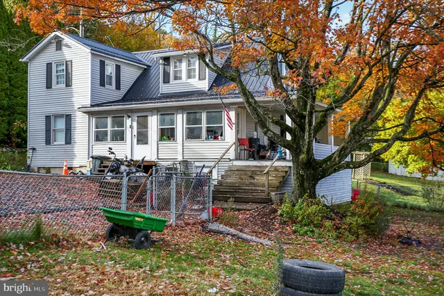 a view of a house with a yard and sitting area