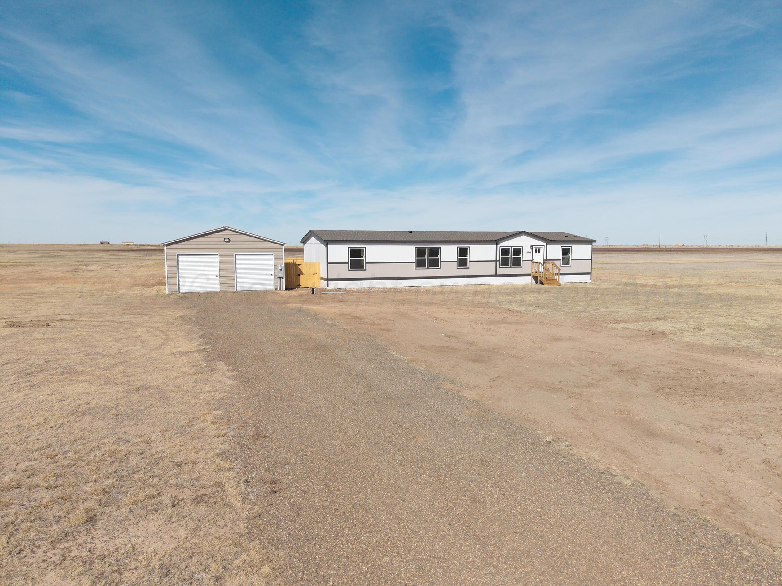 a view of a big room with wooden floor and windows