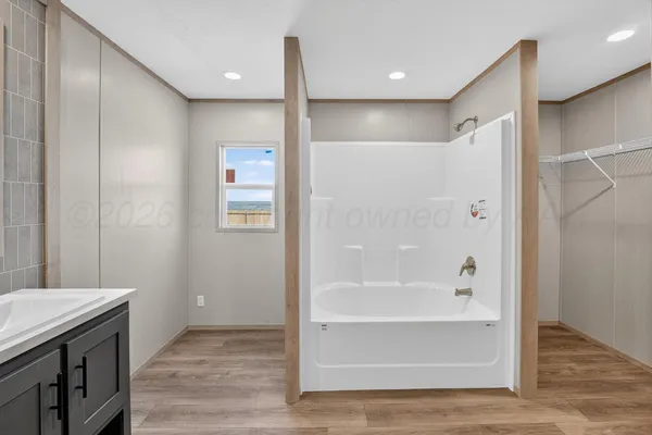 a bathroom with a bathtub and a shower
