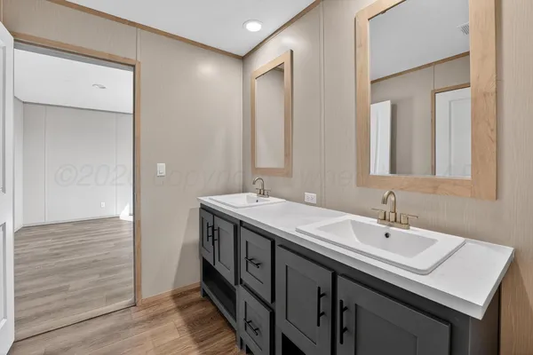 a bathroom with a double vanity sink and a mirror